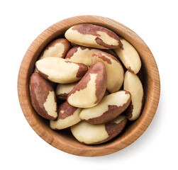Brazil nuts in a wooden plate on a white. Top view