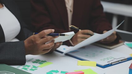 Sustainable business partners discuss renewable energy models and ESG investment strategies for a greener future - Powered by Adobe