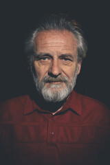Obraz premium Older man in red shirt waiting for something on night city location