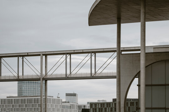 Building facade composed of geometry, structure and minimal lines creating a rhythmic pattern across the architectural detail presented through a cold grey exterior in a clean modern abstract study