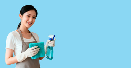 A smiling young Asian woman in gloves holds a spray bottle and a cleaning cloth. The cleaning banner has an empty space for the text.