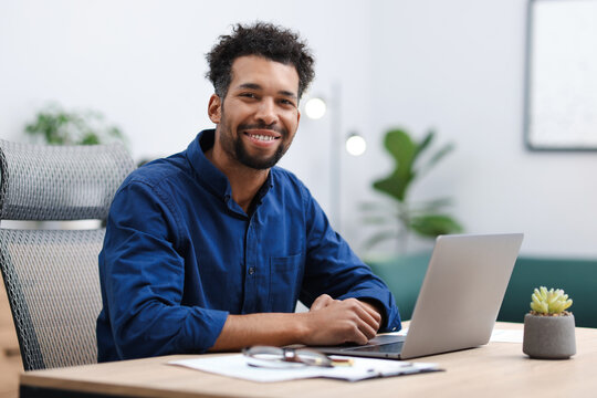 Portrait of man at table in office