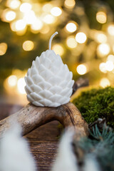 handmade soy wax candles in the cozy room, Christmas lights in the background. 