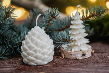 handmade soy wax candles in the cozy room, Christmas lights in the background. 