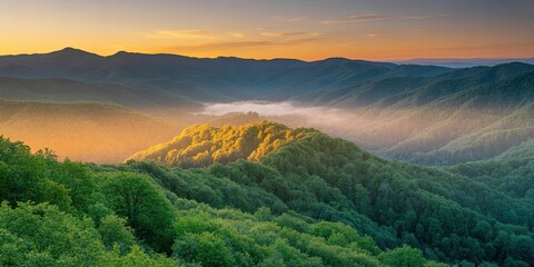 Spectacular sunrise paints mountain peaks in vibrant greens and warm gold