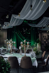 Elegant wedding reception with green decor and candlelit tables