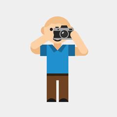 Flat design vector illustration of a smiling cartoon photographer holding a camera and taking a picture.