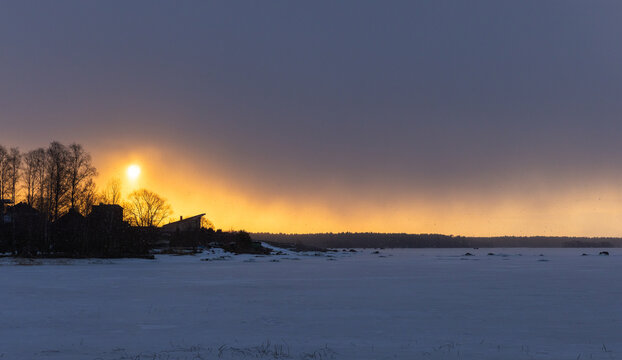 Natural winter sunset landscape photography featuring bare trees silhouettes