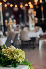 Elegant wedding reception with floral centerpiece and warm lighting