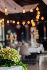 Elegant indoor wedding reception with floral decoration and ambient lighting