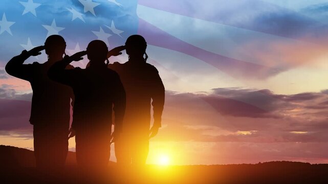 Silhouettes of soldiers saluting on background of sunset or sunrise and USA flag. Veterans Day, Memorial Day, Independence Day. America celebration.