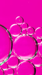 oil drops on water on a pink background