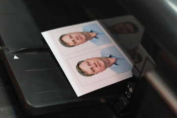 Printing documents on a printer. Photo studio service - creating photos for passports, passes ID...