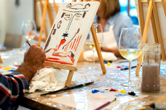 Person enjoying sip and paint art workshop