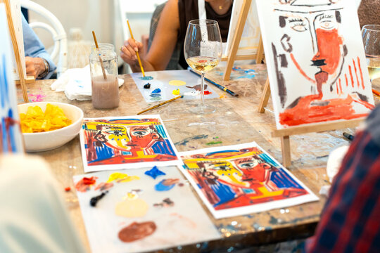 People enjoying creative art workshop sipping beverages