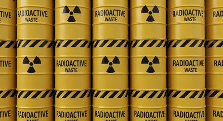 A close up view of neatly stacked yellow barrels featuring the radioactive warning symbol, providing a visual representation of hazardous materials.