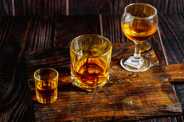 Strong alcohol drink. Whisky in glass, Whisky, bourbon or cognac. Hard strong alcoholic drinkIn various glass forms