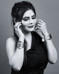 Monochrome fashion portrait of a confident woman in a black one-shoulder dress with eyes closed, symbolizing elegance, peace, and inner strength.