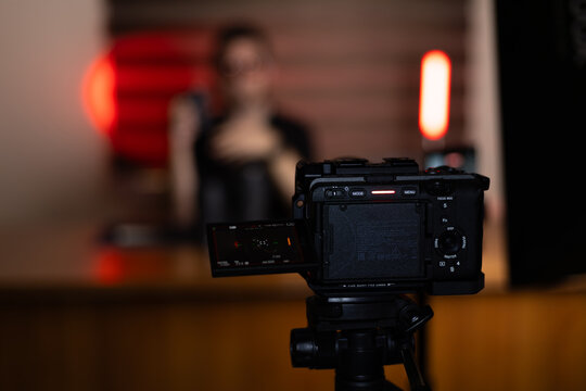 The camera is recording a man who is likely creating video content for a blog