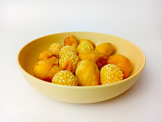 Onde-onde and Molen Pisang, Indonesian traditional snack, served on a round plate, isolated on white background.