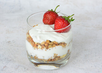 layered Yogurt Parfait with Granola and Fresh Strawberries in a drinking glass