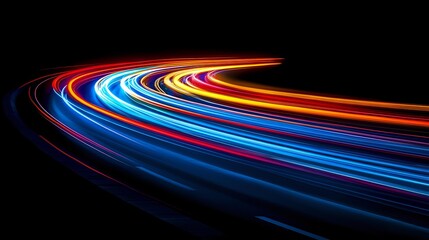 Colorful light trails curve along dark background, creating dynamic motion effect of vehicle headlights and taillights on highway at night.