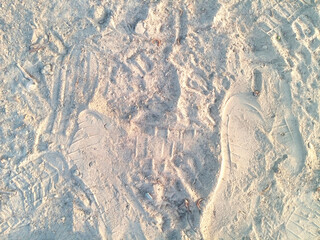 Shoe Footprints and Textured Marks on Soft Sandy Ground Creating Natural Outdoor Pattern Background Scene