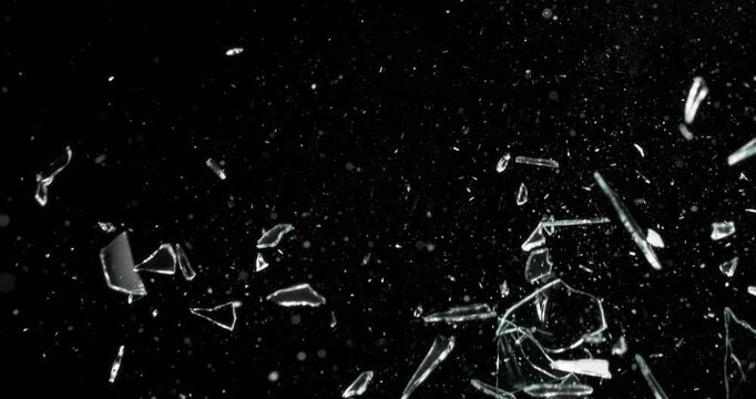 This stunning video showcases the mesmerizing effects of spontaneous glass breakage on a black background, ideal for motion graphics, artistic displays, and various visual effects applications