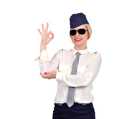 A beautiful flight attendant in uniform shows the OK sign. Transport and service sector concept