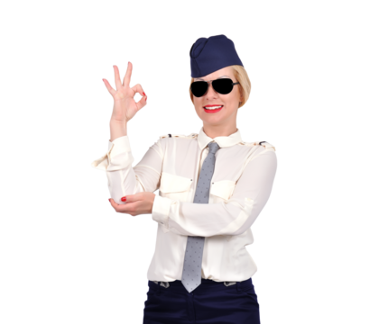 A beautiful flight attendant in uniform shows the OK sign. Transport and service sector concept