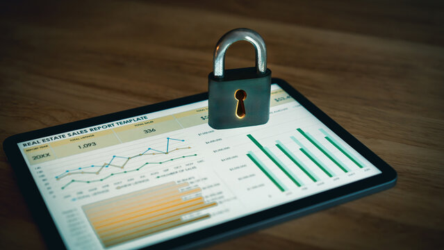 Padlock on digital tablet displaying real estate sales report charts representing secure financial data and protection of property analytics
