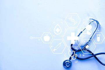 Stethoscope with virtual medical icons on blue background with copy space. Healthcare technology, medical research, and digital health concept.