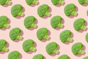 Top-down flatlay pattern of broccoli on pastel green background, subtle shadows, soft diffused light, minimalist repeat design highlighting natural color and floret details.
