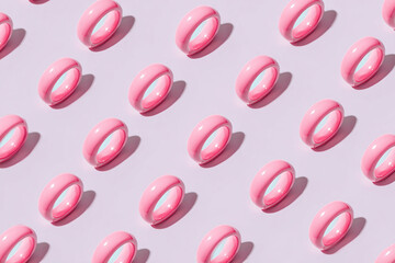 Top-down repeating pattern of rings on soft beige background, clean minimalist style, soft shadows, focus on metallic details and subtle textures, uniform arrangement.