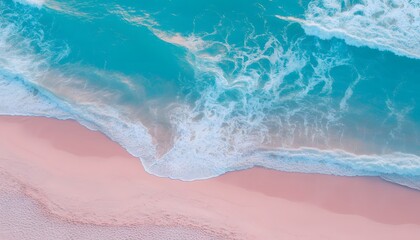 Fototapeta premium Aerial view of gentle ocean waves washing over a soft pink sandy beach