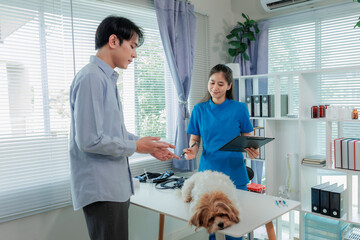 Indoor veterinary clinic with dog, vet, and owner during pet health consultation and treatment.