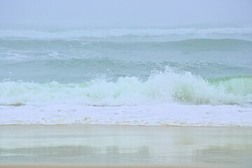 Foggy beach along the Atlantic ocean on a summer morning in Over, Portugal 