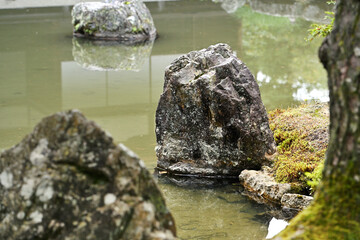 Stones in pond  trees and greenery in the Japanese garden of Ginkakuji Temple