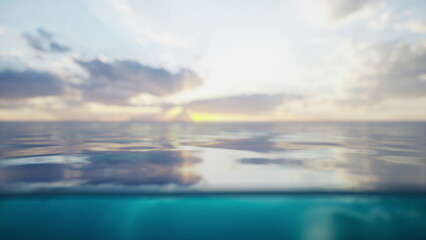 Golden hues illuminate the sky as the sun sets over the horizon. Gentle waves ripple across the ocean surface, reflecting the soft clouds and creating a peaceful atmosphere.