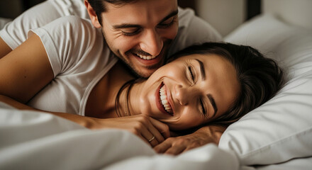Close-up of a smiling couple in bed, showcasing intimacy and happiness.  Represents love, affection, and morning joy
