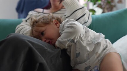 Tender toddler resting head on family member showing calm affectionate moment of closeness