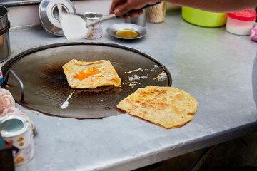 Hot crispy fried Roti in frying pan