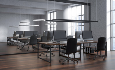 Modern office interior with long wooden desks, computer monitors, and stylish chairs, minimalistic design, large windows, daylight setting, 3D Rendering
