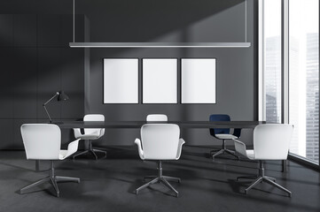 Fototapeta premium Contemporary meeting room with blank posters on dark wall, minimal furniture design, large windows in background. Concept of advertising or interior display. 3D Rendering