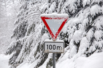 snow-covered roadside traffic sign.
