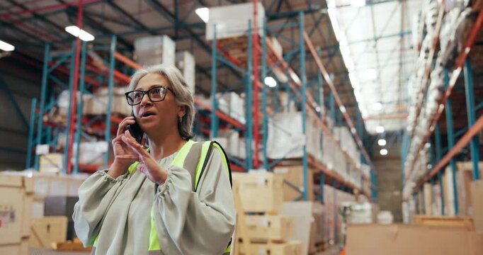Woman, logistics and talk with phone call in warehouse for online order, shipping feedback and inquiry. Mature person, mobile and discussion for inventory, contact supplier and chat for distribution