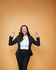  Portrait of a smiling young business woman pointing up Poster with copy space.
