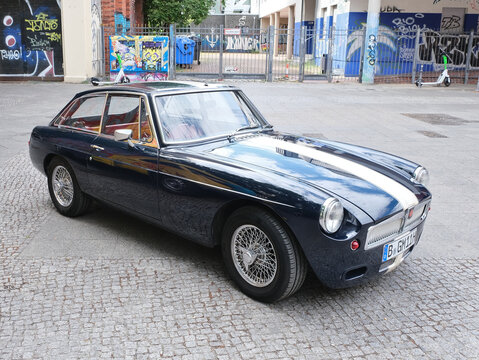 Berlin, Germany, July 13, 2022, vintage MG MGC GT in black with white rally stripe on hood and roof.