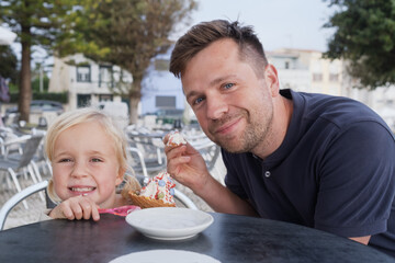 Girl Eating Ice Cream with Her Dad at a Cafe
