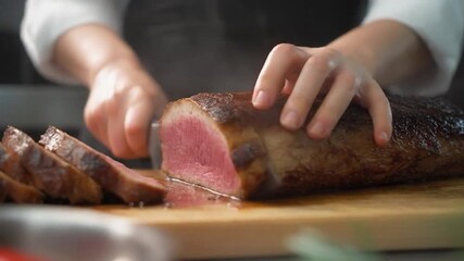 Professional chef slicing perfectly cooked medium rare roast meat on wooden cutting board - Powered by Adobe